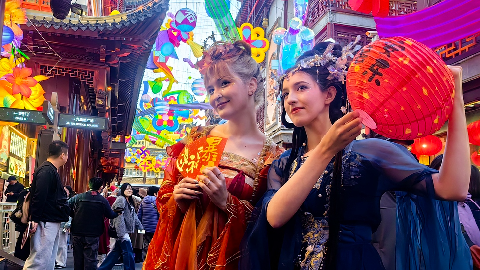 Tourists from Russia dressed in traditional Chinese Hanfu pose for a photo at Yuyuan Garden in Shanghai, February 16, 2026. /VCG