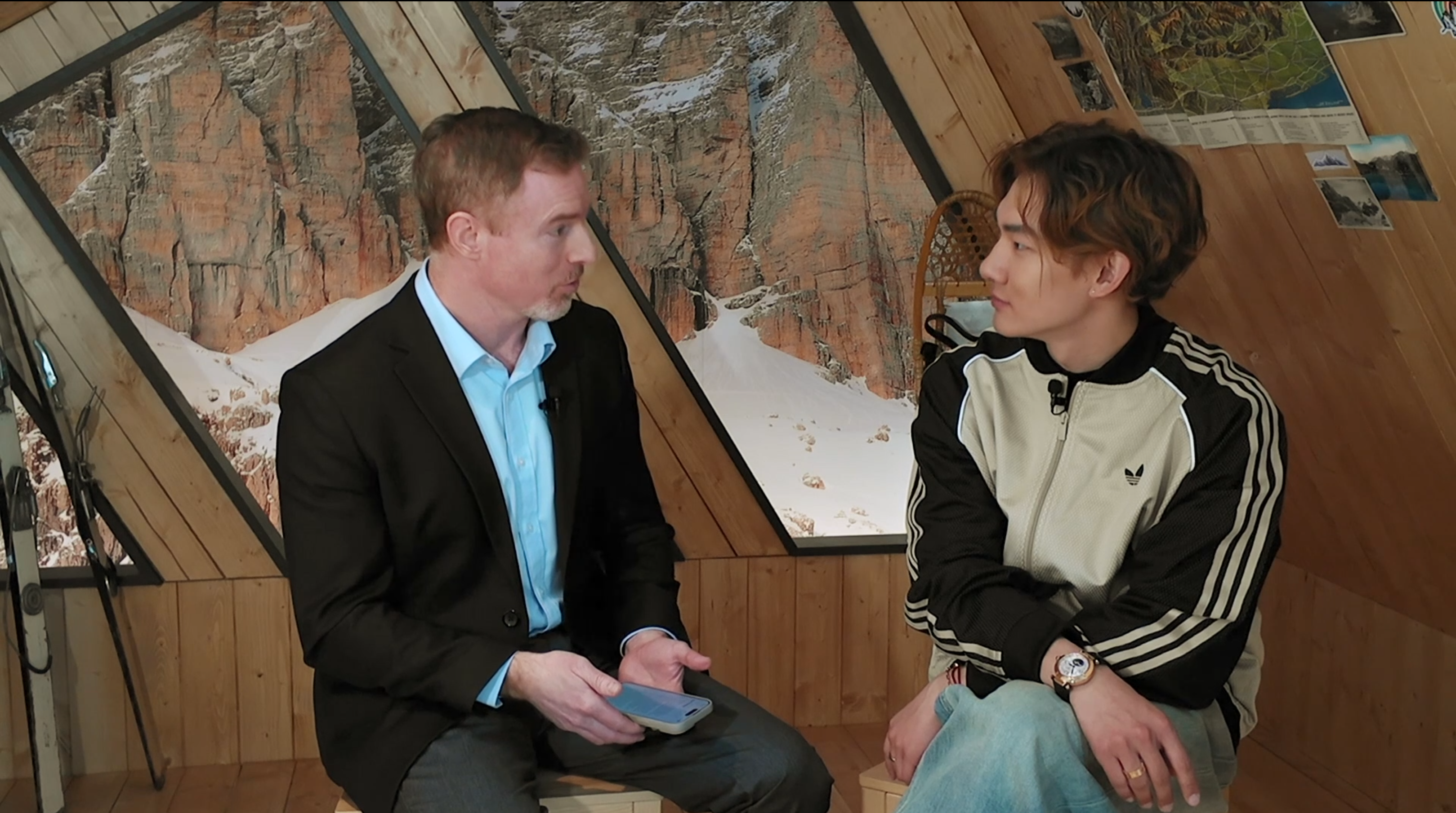 China's men's snowboard big air gold medalist Su Yiming (R) speaks to CGTN Sports Scene's Greg Laffradi during the 2026 Milano Winter Olympics in Milan, Italy. /CGTN