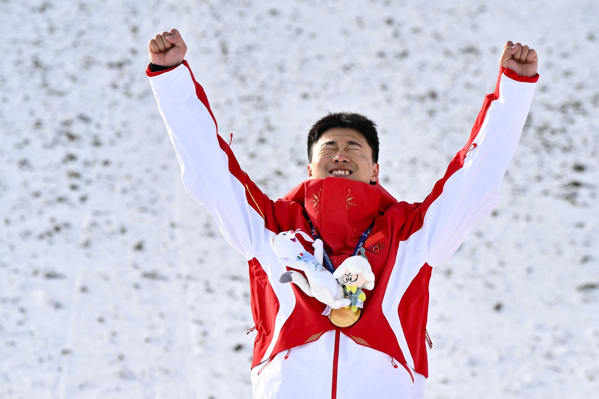Wang Xindi of China celebrates on the podium after winning the men's freestyle skiing aerials gold medal at the 2026 Milano Cortina Winter Olympics in Livigno, Italy, February 20, 2026. /VCG