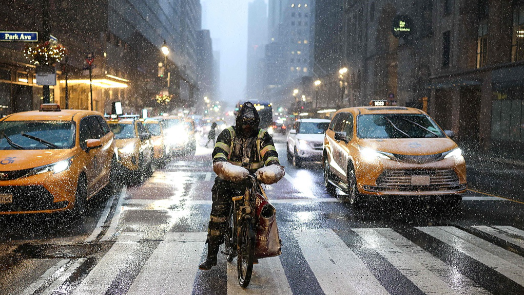 A man delivering food by bike rides along 42nd Street in the Manhattan borough of New York City on February 22, 2026. /VCG