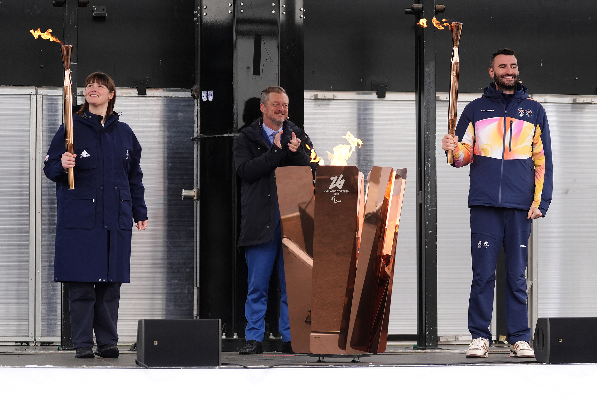 L-R: Millie Knight of Great Britain, IPC (International Paralympic Committee) President Andrew Parsons and Andrea Macri of Italy take part in the flame lighting ceremony for the 2026 Milano Cortina Winter Paralympics in Stoke Mandeville, England, February 24, 2026. /VCG