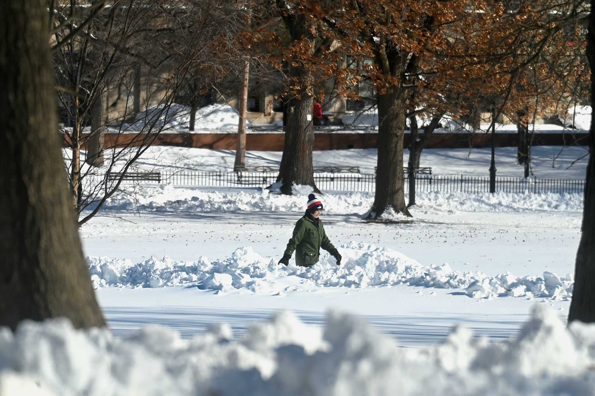 A woman walks through thigh-deep snow in Fairfield, Connecticut, the U.S., February 24, 2026. /VCG