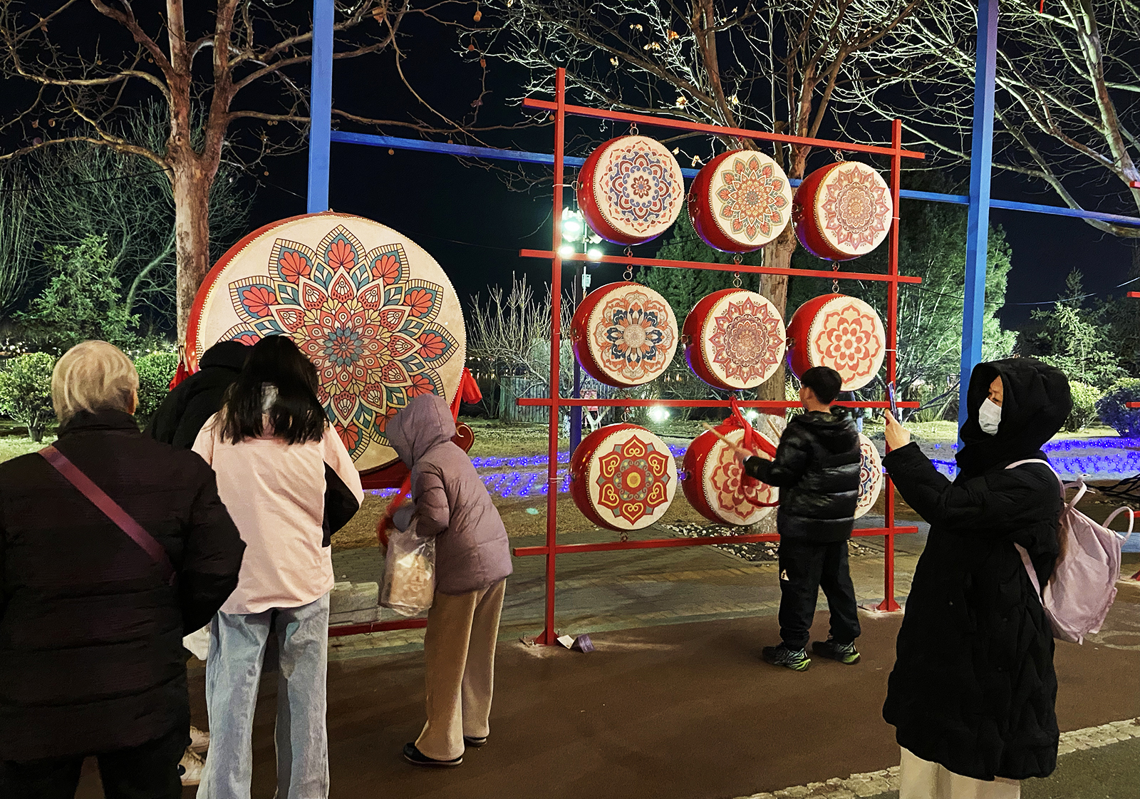 Visitors beat drums to celebrate the Spring Festival at South Lake Park in Tangshan, Hebei Province. /CGTN