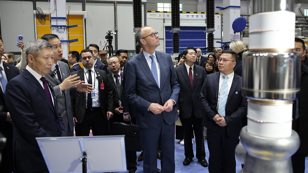 German Chancellor Friedrich Merz listens to an explanation at the facilities of Siemens Energy in Hangzhou City, east China's Zhejiang Province, February 26, 2026. /VCG