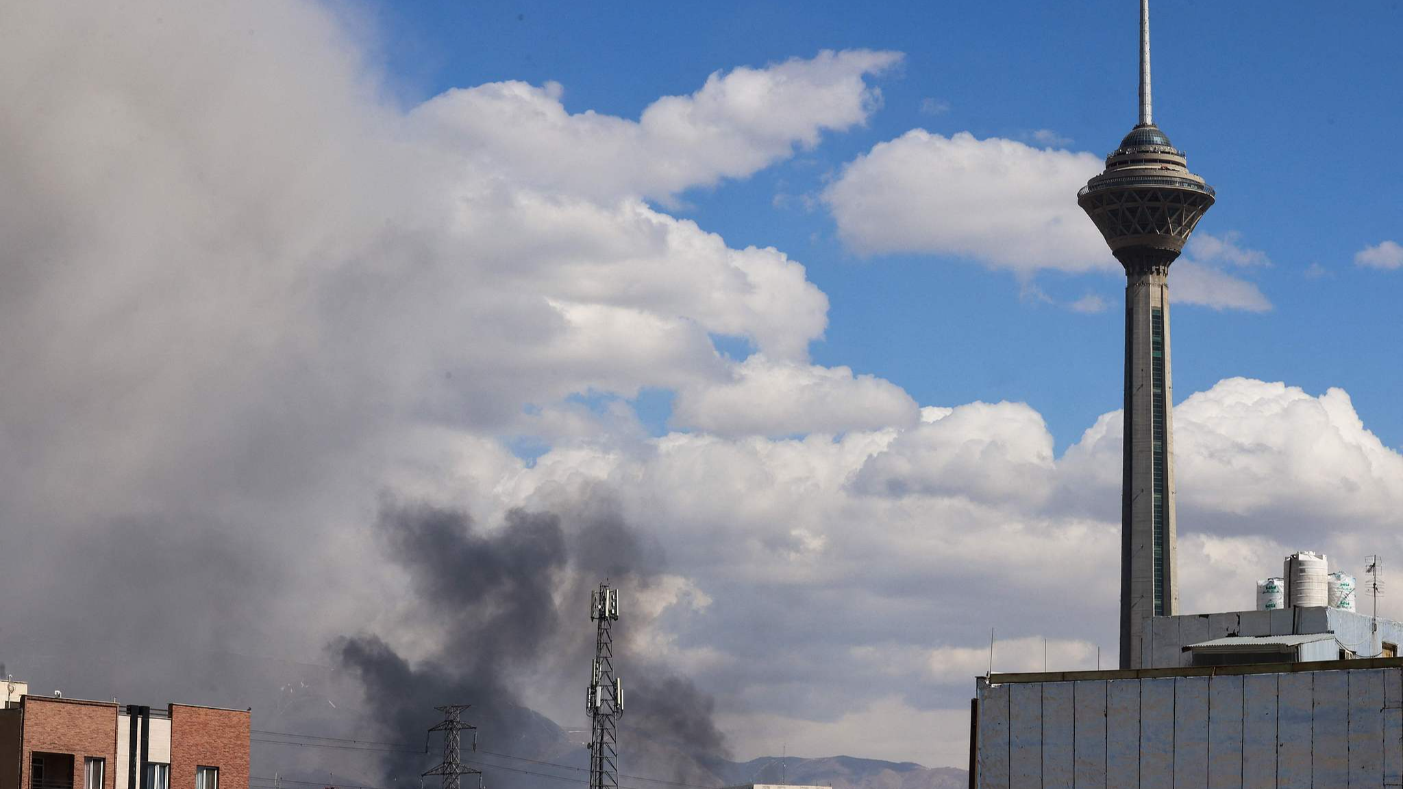 A plume of smoke rises following reported explosions in Tehran, Iran, March 1, 2026. /VCG