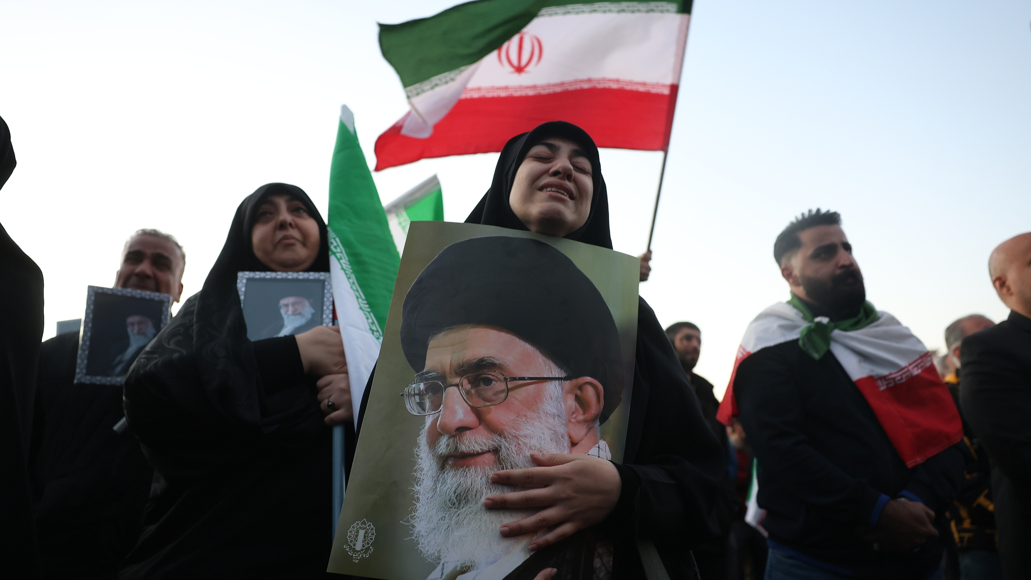 Mourners hold pictures of Iranian Supreme Leader Ayatollah Ali Khamenei at Enqelab Square in Tehran, Iran, March 1, 2026. /CFP