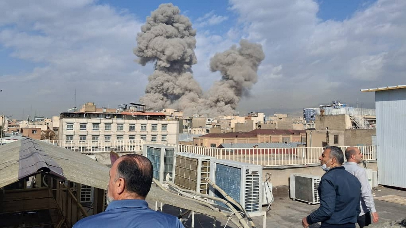 People watch as smoke rises on the skyline after an explosion in Tehran, Iran, February 28, 2026. /CFP