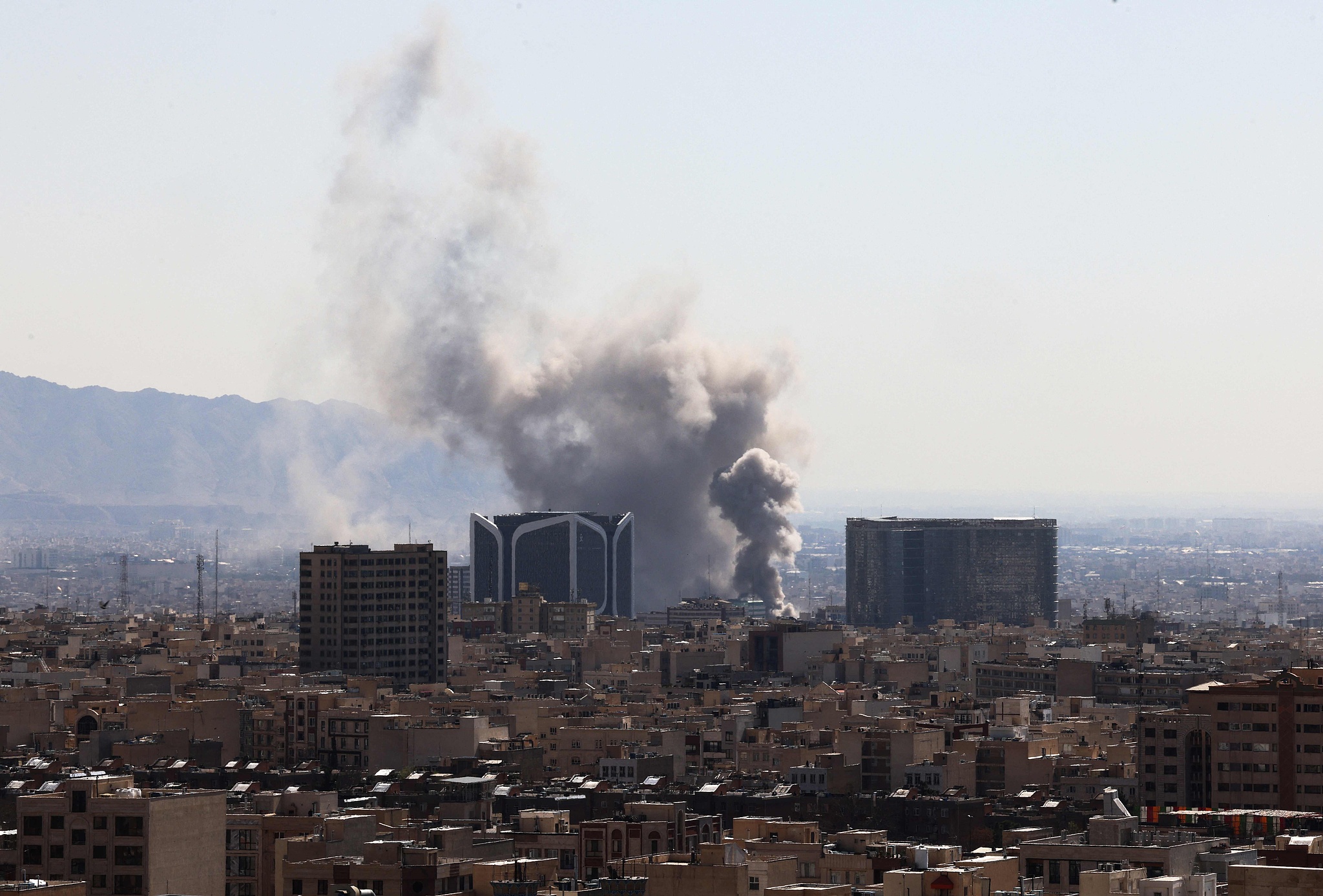 Plumes of smoke rise following reported explosions in Tehran on March 1, 2026. /VCG