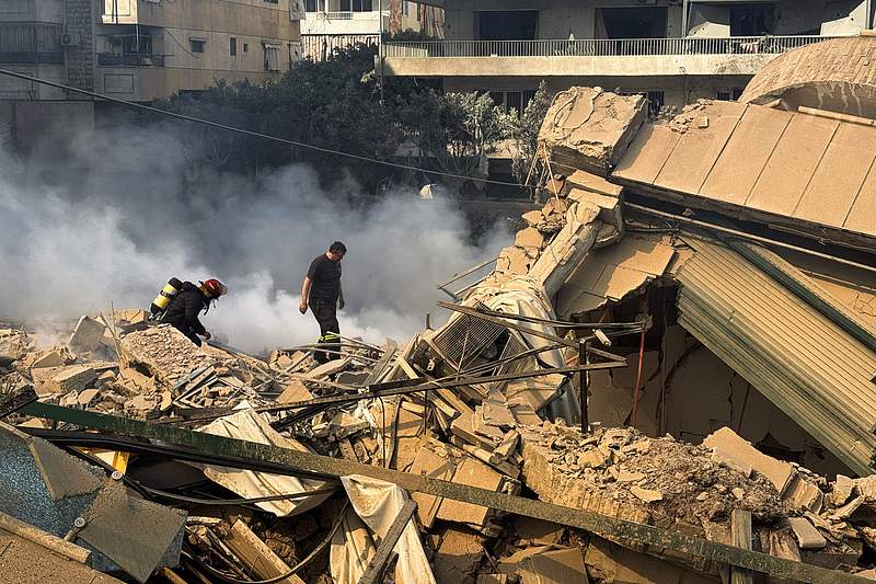 Firefighters inspect destruction at a site of an Israeli airstrike in the southern suburbs of Beirut, March 3, 2026. /VCG