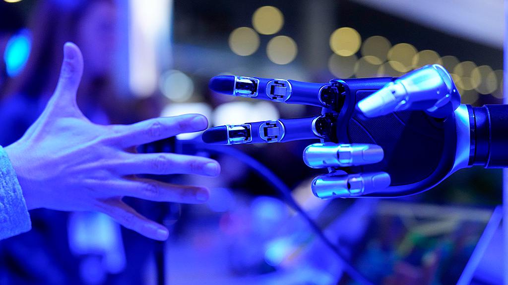 A visitor plays rock-paper-scissors with a machine at the Honor stand during the MWC in Barcelona, Spain, March 2, 2026. /VCG