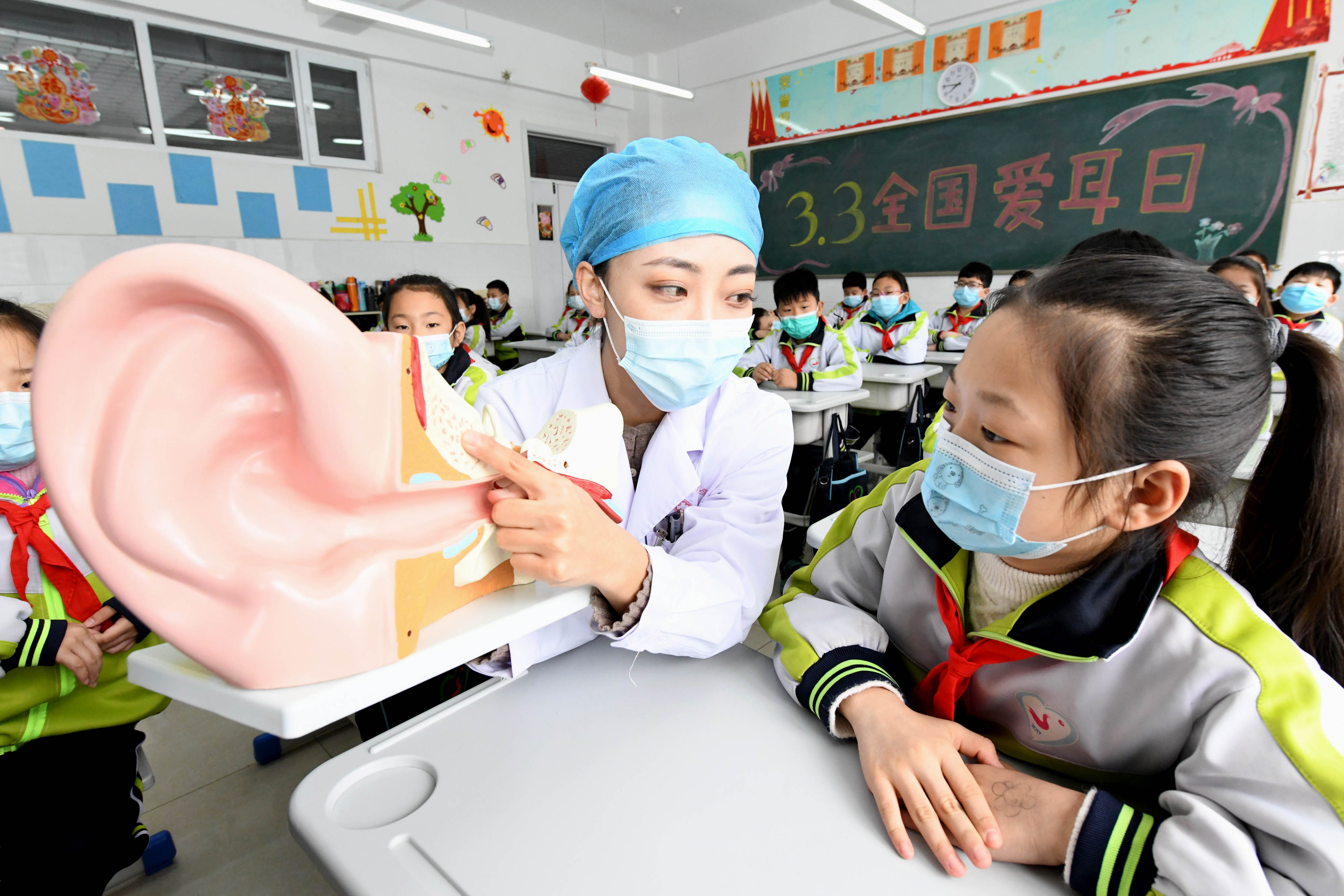 A doctor explains the structure of the hearing system to elementary school students in Shijiazhuang, north China's Hebei Province. /ICphoto