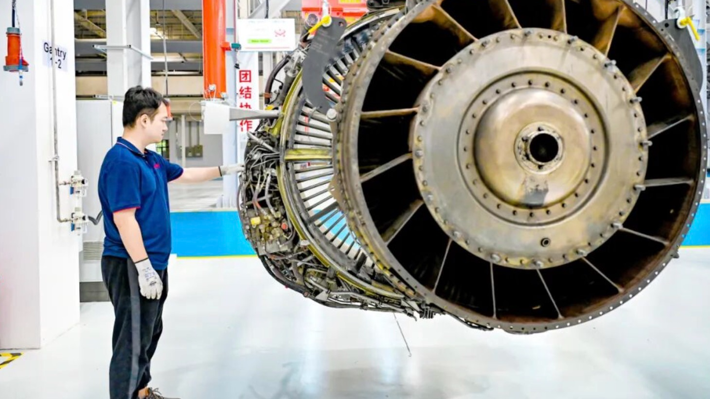 An engineer conducts a routine inspection on an aircraft engine. /Aerospace Engineering Exhibition