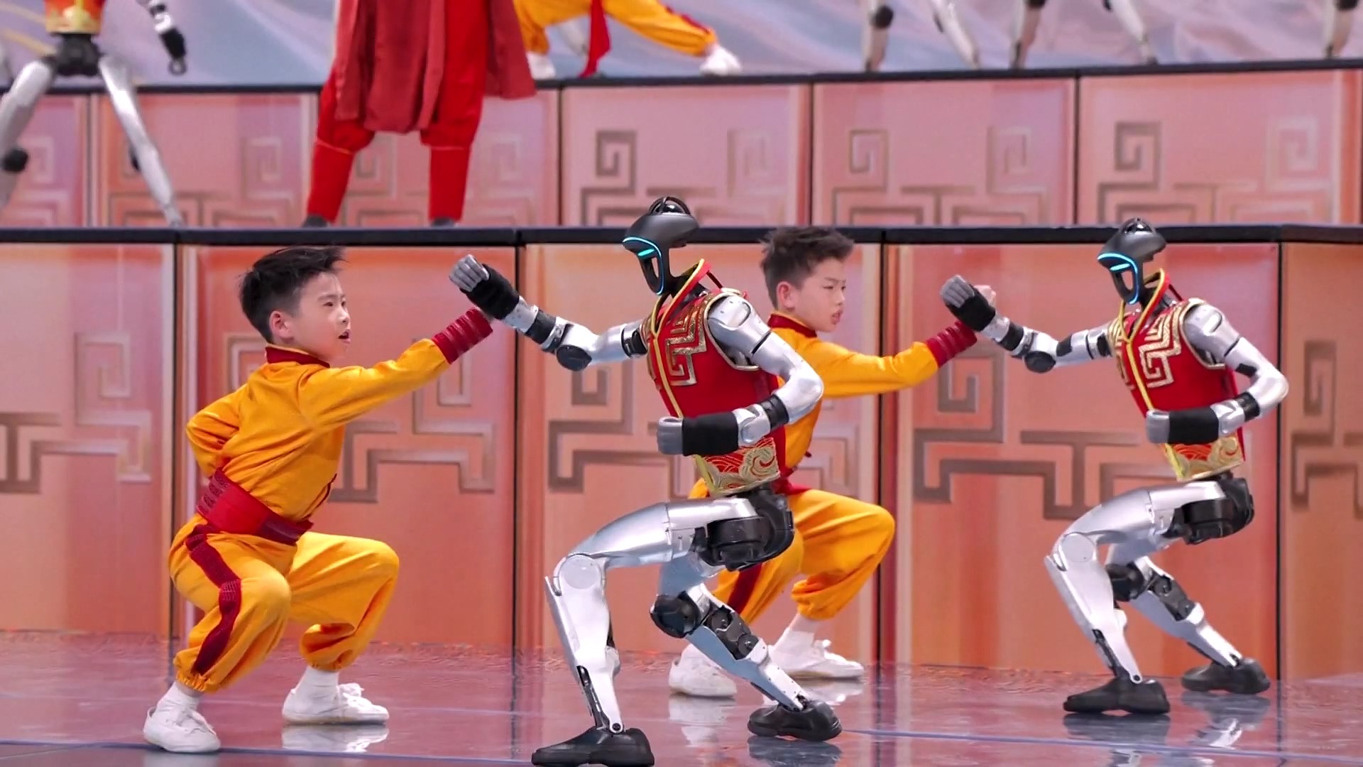 Robots perform kung fu with children on the stage of China Media Group's Spring Festival Gala, Beijing, February 16, 2026. /CMG