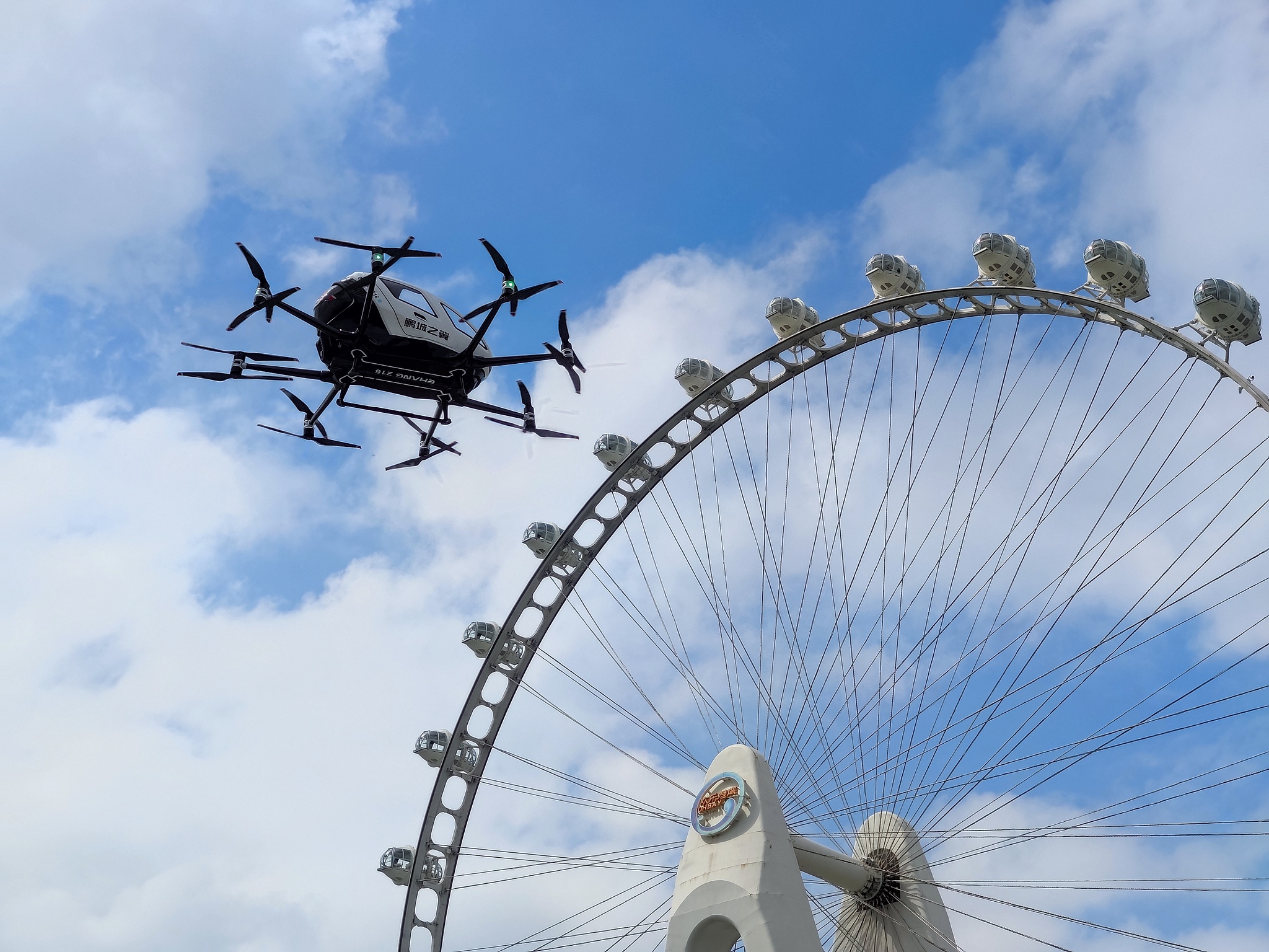 An EH216-S passenger-carrying unmanned aerial vehicle (UAV), an electric vertical takeoff and landing (eVTOL) aircraft developed by EHang, conducts a test flight in Shenzhen, Guangdong Province, south China, March 14, 2025. /VCG