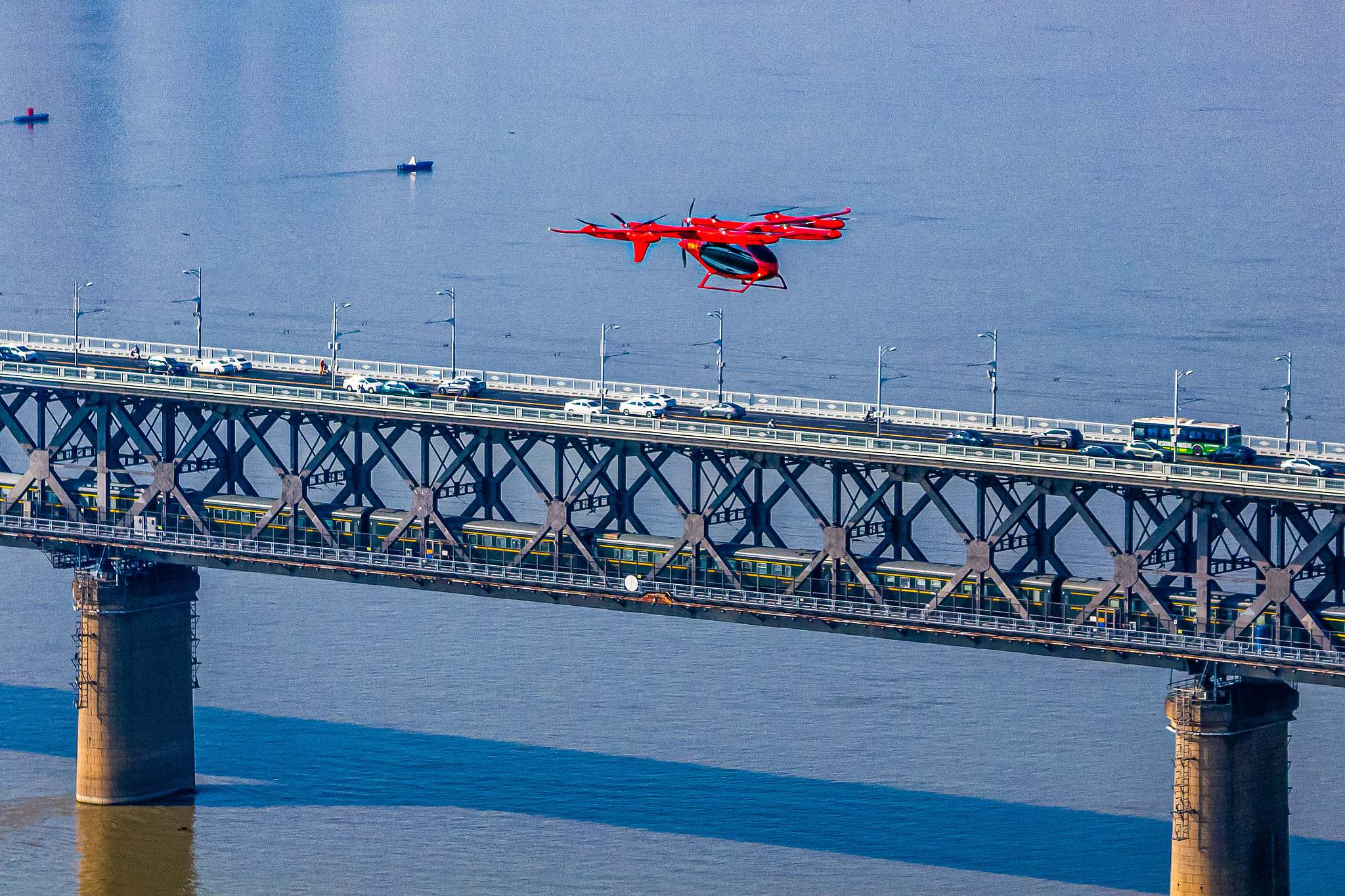 A 2-tonne class eVTOL aircraft developed by AutoFlight carries a red life raft and airdrops it into a designated section of the Yangtze River during an emergency rescue drill in Wuhan, Hubei Province, central China, July 15, 2025. /VCG