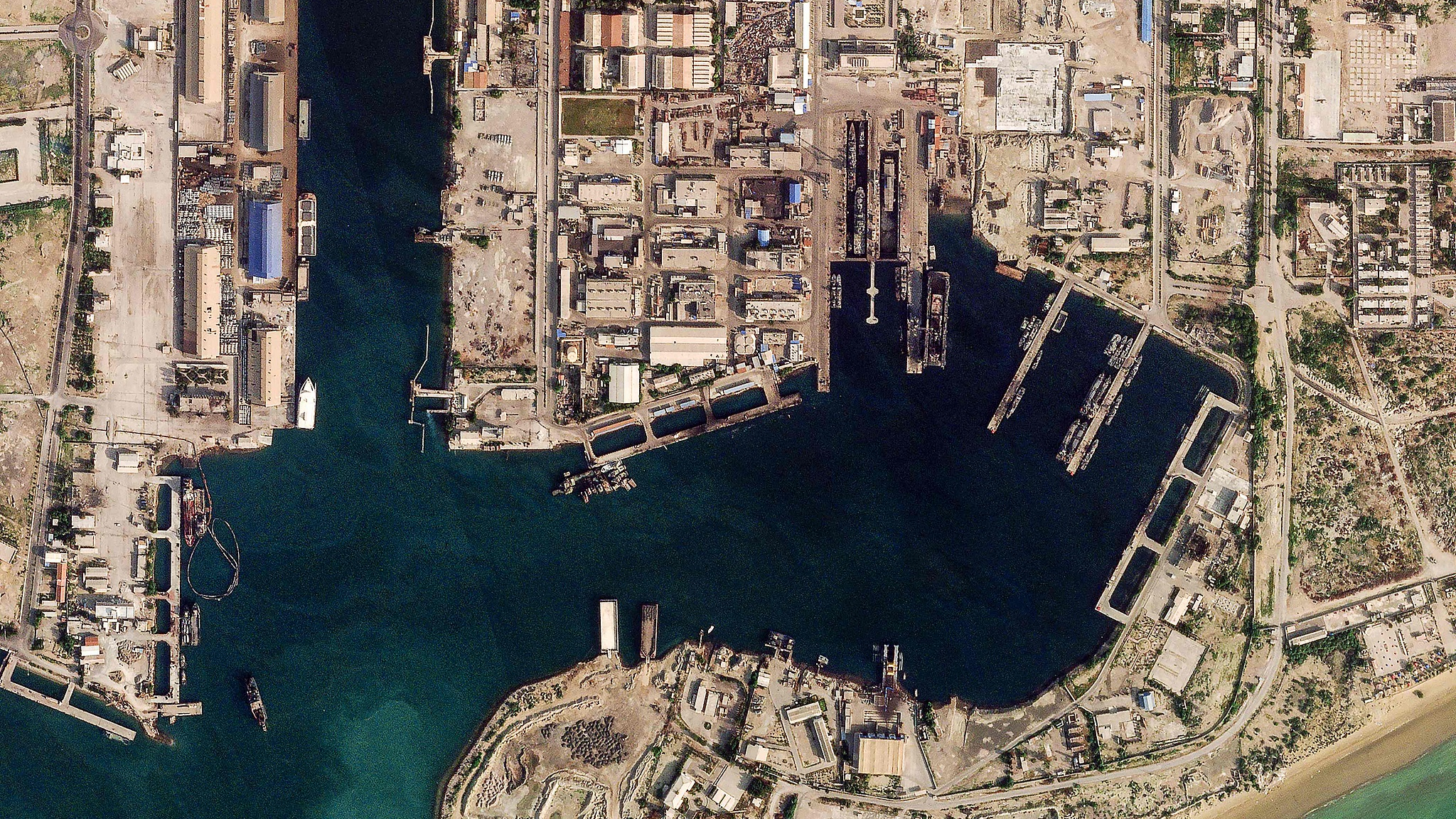 This handout satellite image taken by 2026 Planet Labs PBC shows damage at the military harbor in Iran's southern port of Bandar Abbas along the Strait of Hormuz, March 4, 2026. /VCG