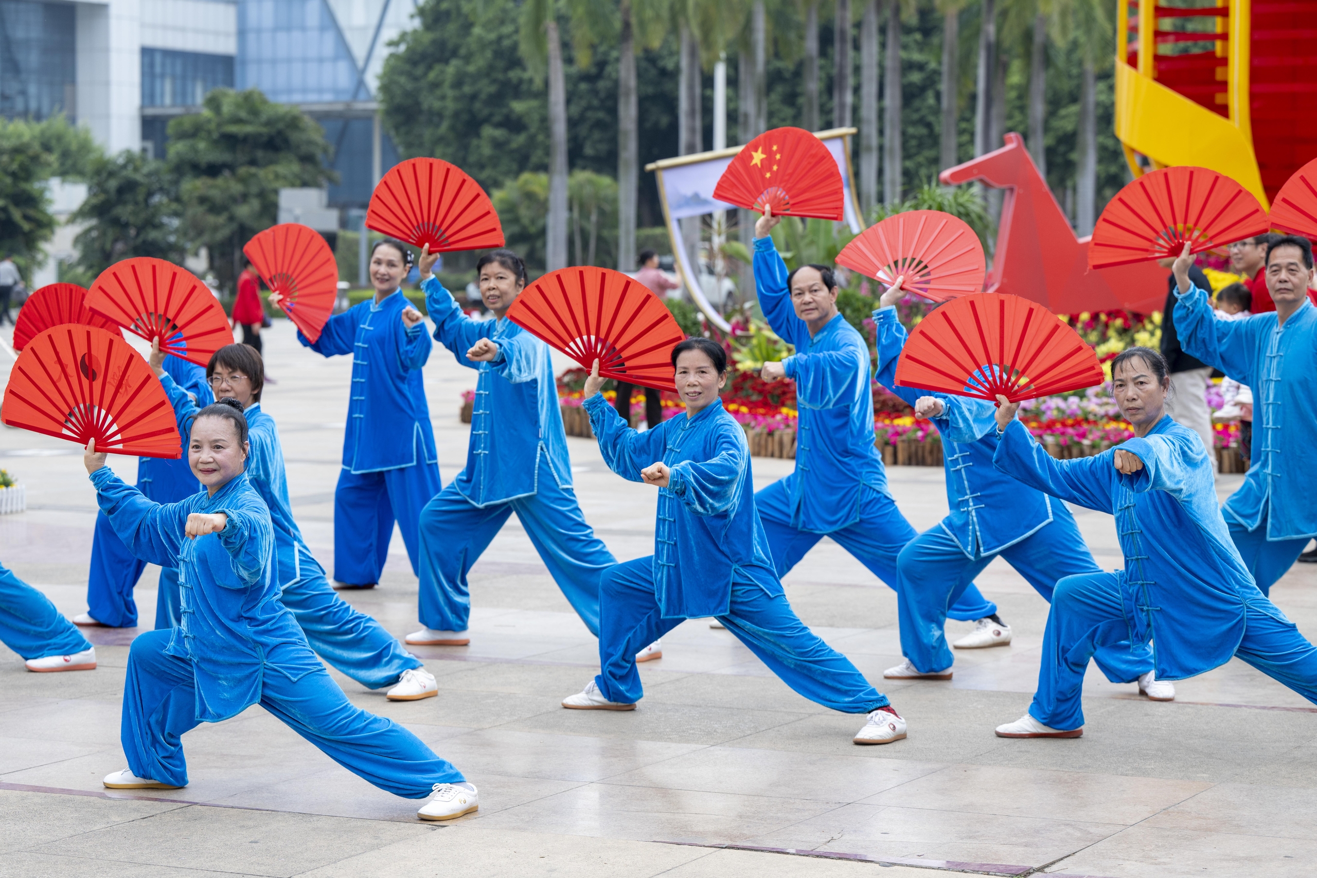 A group of seniors perform with tai chi fans in Wuzhou, Guangxi on February 24, 2026. /IC
