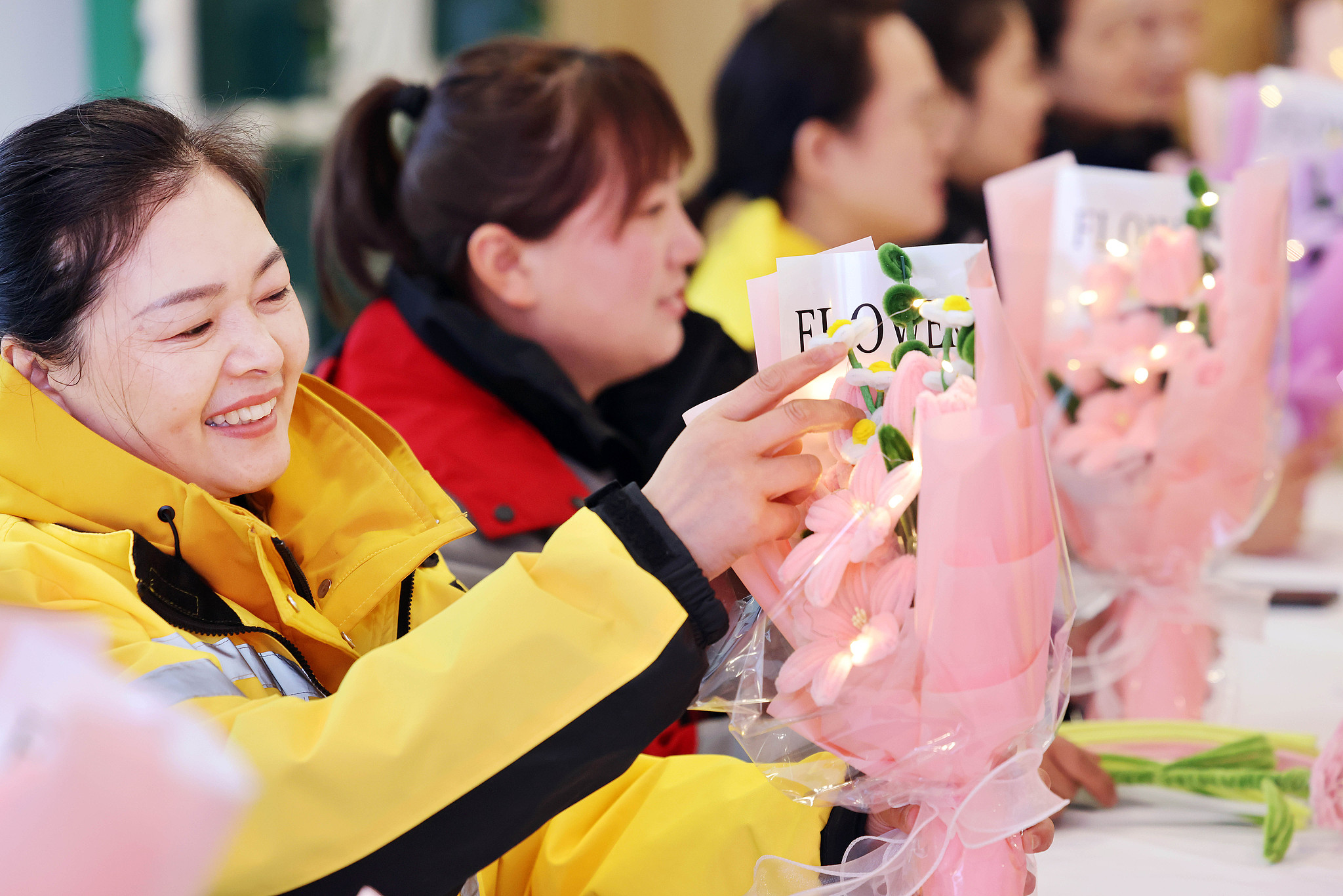 Women make flower decorations at an activity held by a community to celebrate International Women's Day in Lianyungang, east China's Jiangsu Province, March 6, 2026. /VCG