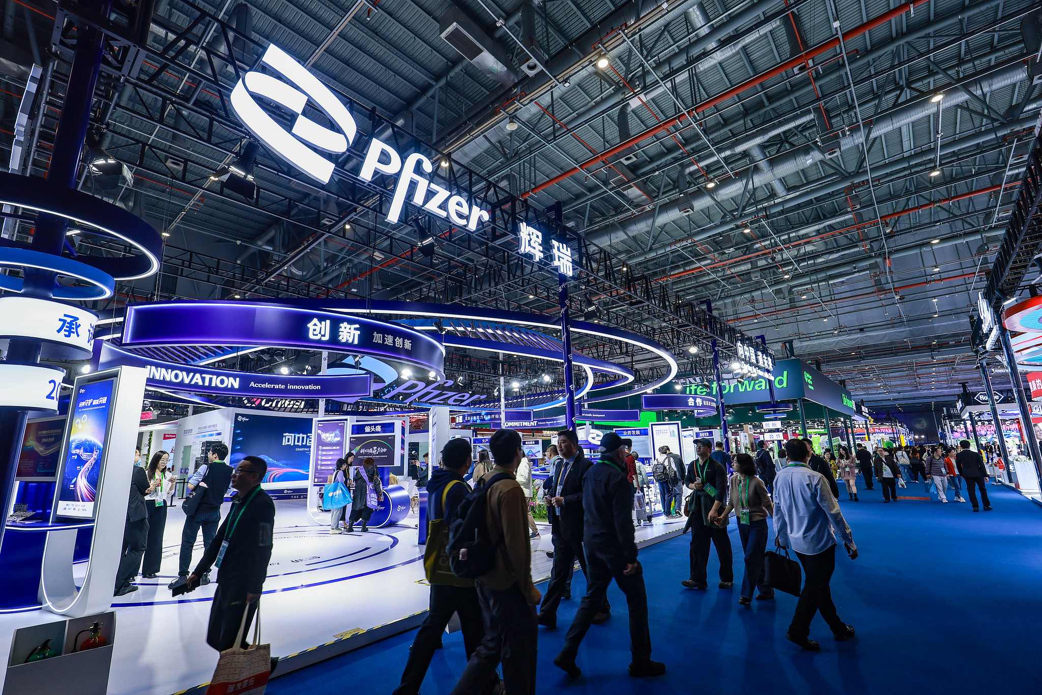 Visitors explore the Pfizer booth during the China International Import Expo (CIIE) in Shanghai on November 8, 2025. /VCG