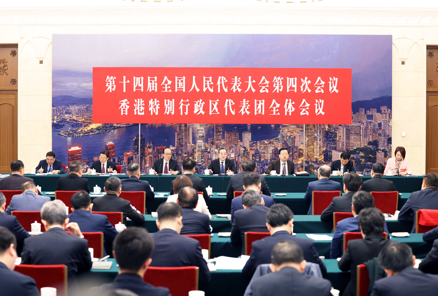 Ding Xuexiang, a member of the Standing Committee of the Political Bureau of the Communist Party of China Central Committee and vice premier, attends group deliberations with deputies from Hong Kong Special Administrative Region at the fourth session of the 14th National People's Congress in Beijing, China, March 7, 2026. /Xinhua