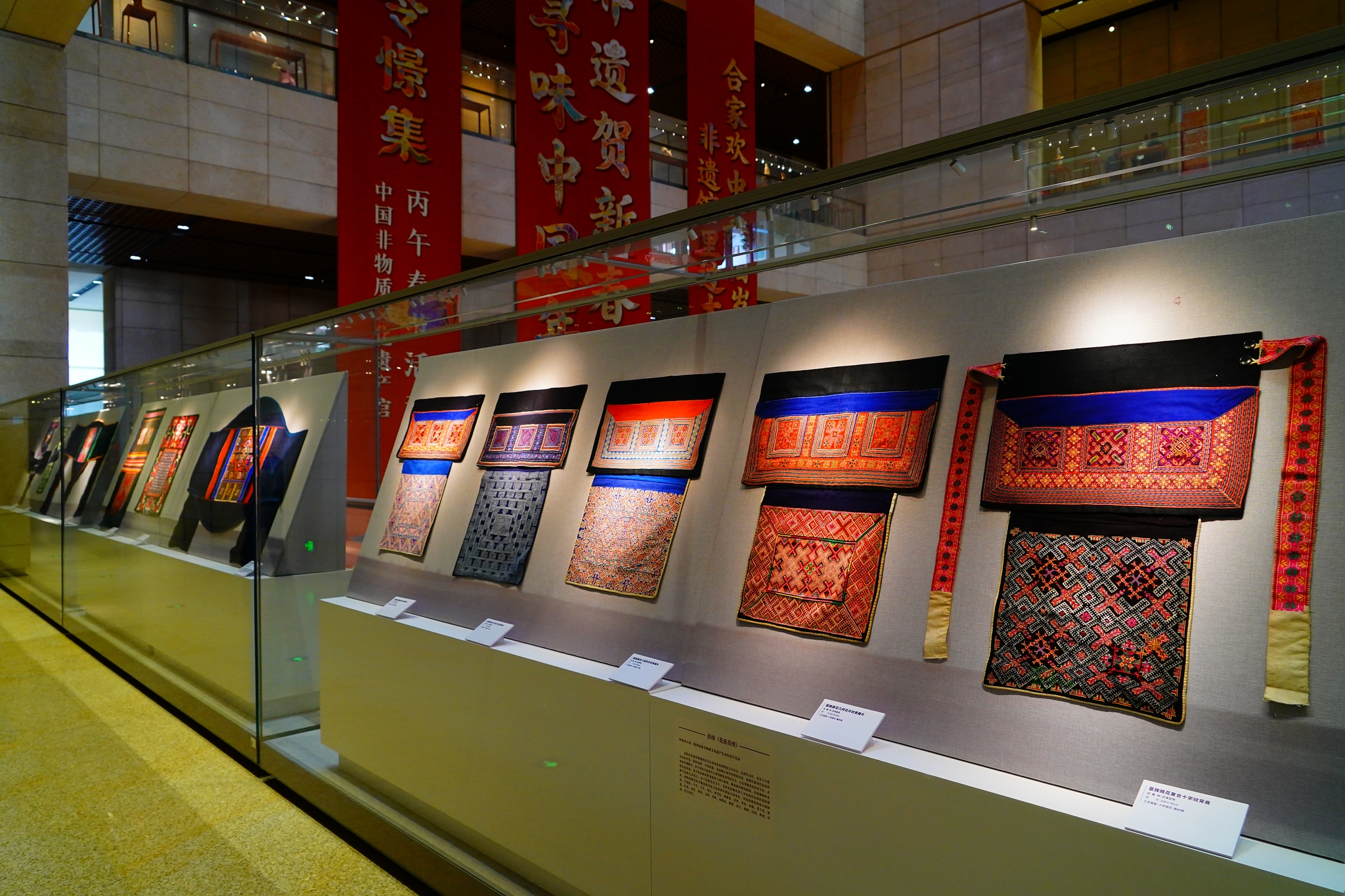 Cloth baby carriers from ethnic groups in southwest China are displayed at the Chinese Traditional Culture Museum in Beijing on January 21, 2026. /VCG