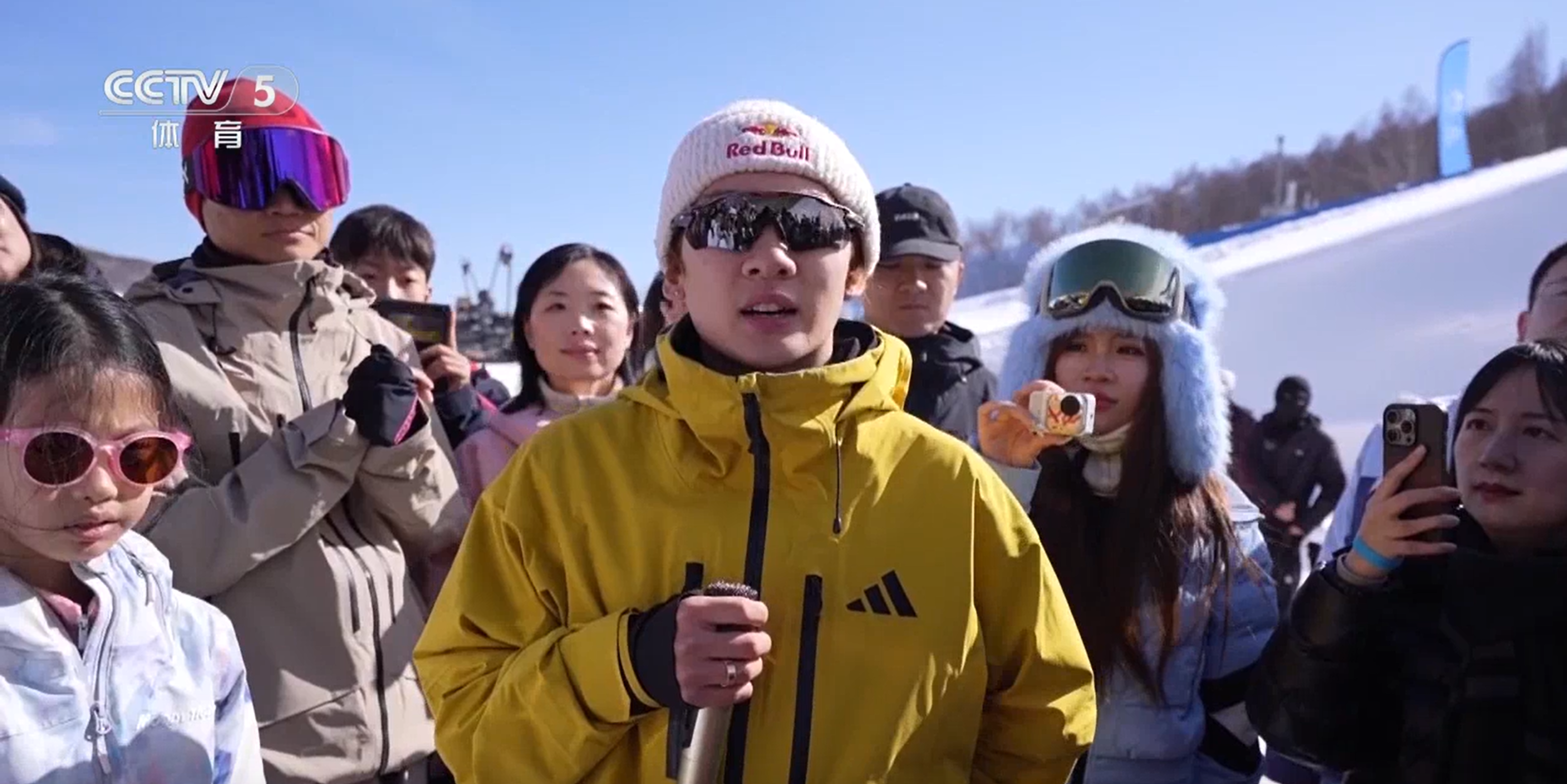 Su Yiming (C) of China speaks to camera after his training session at Genting Snow Park in Zhangjiakou, north China's Hebei Province. /CMG