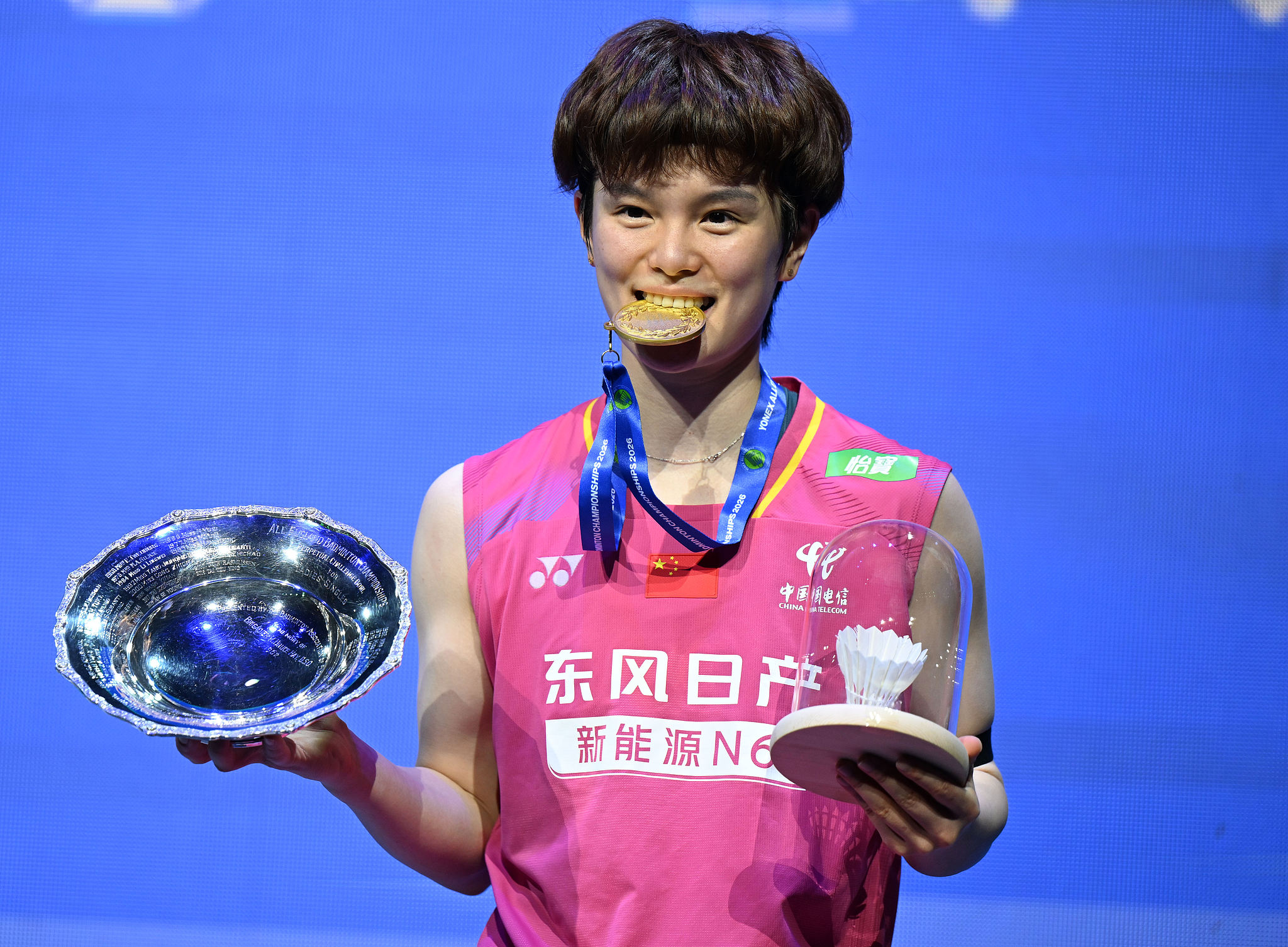 China's Wang Zhiyi poses with her championship medal and trophies after beating the Republic of Korea's An Se-young in the women's singles final at the BWF All England Open in Birmingham, England, March 8, 2026. /VCG