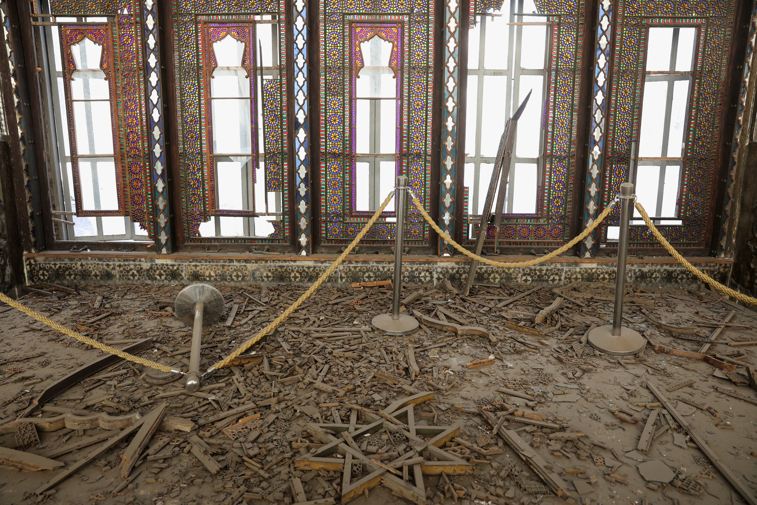 Shards of glass and decorations from the Golestan Palace lay scattered across the ground. /IC