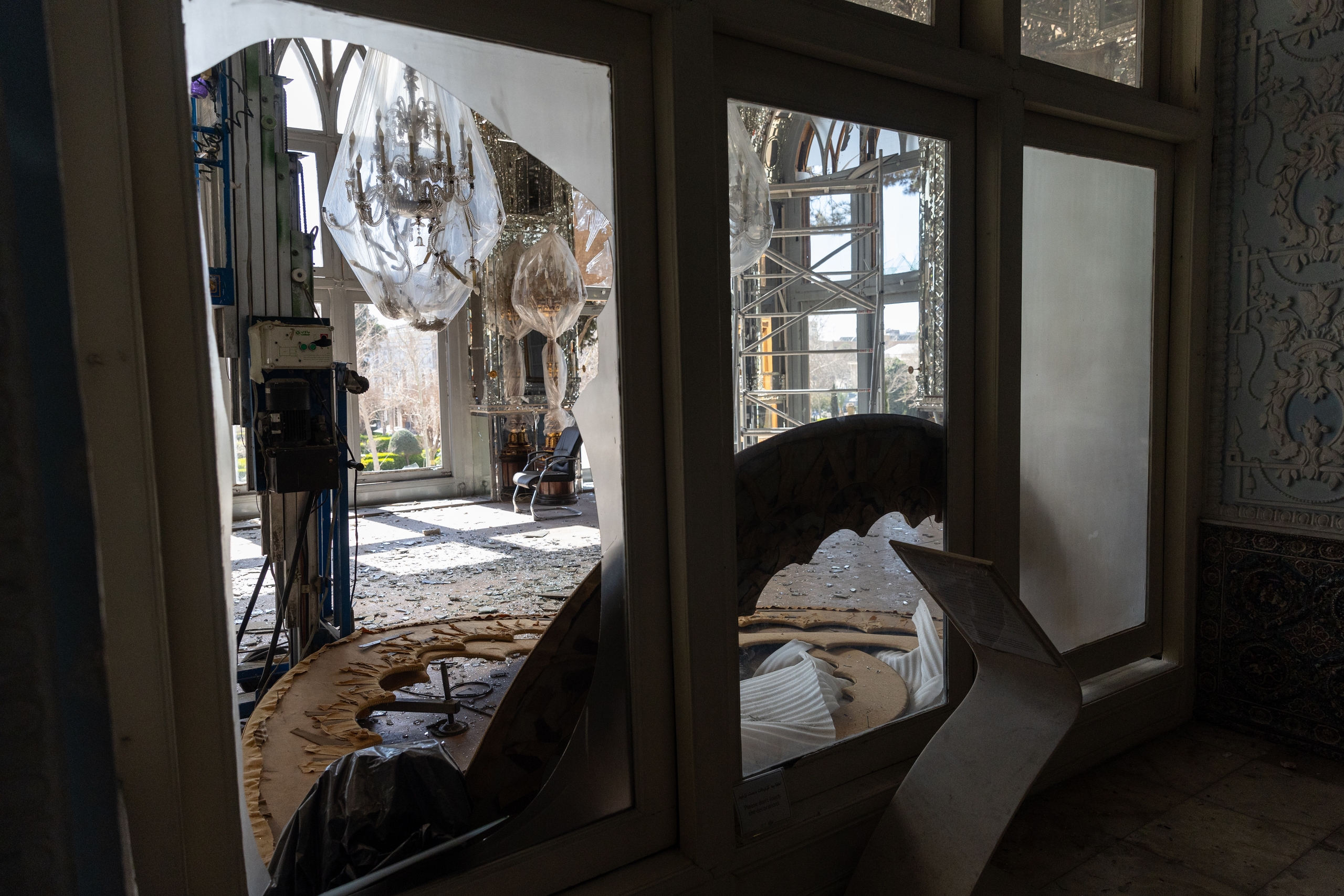 Shards of glass and decorations from the Golestan Palace lay scattered across the ground. /IC