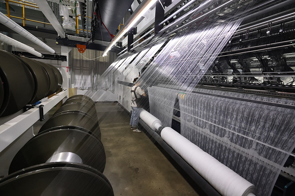 Workers produce lace products on the production line, Fuzhou, southeast China's Fujian Province, September 20, 2024. /VCG