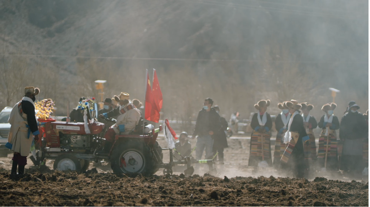Locals operating agricultural machinery at the 