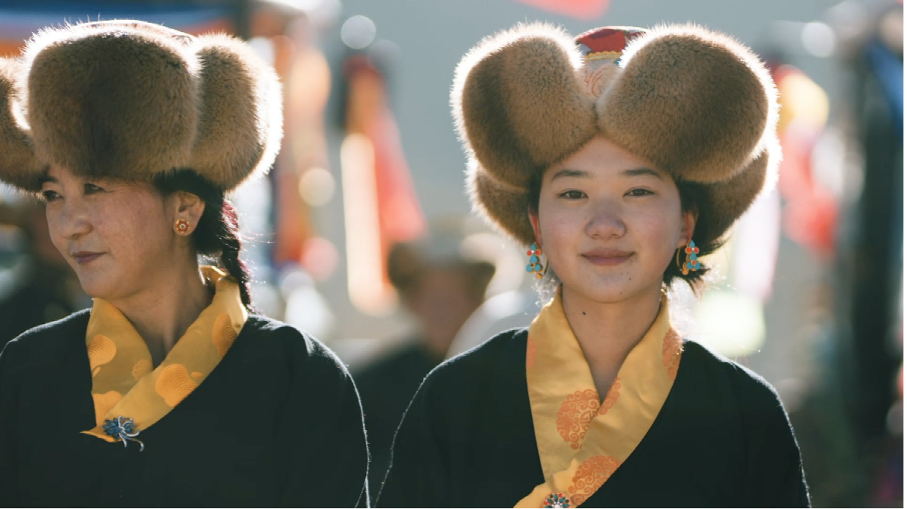 Locals dressed in traditional ethnic costumes take part in the 