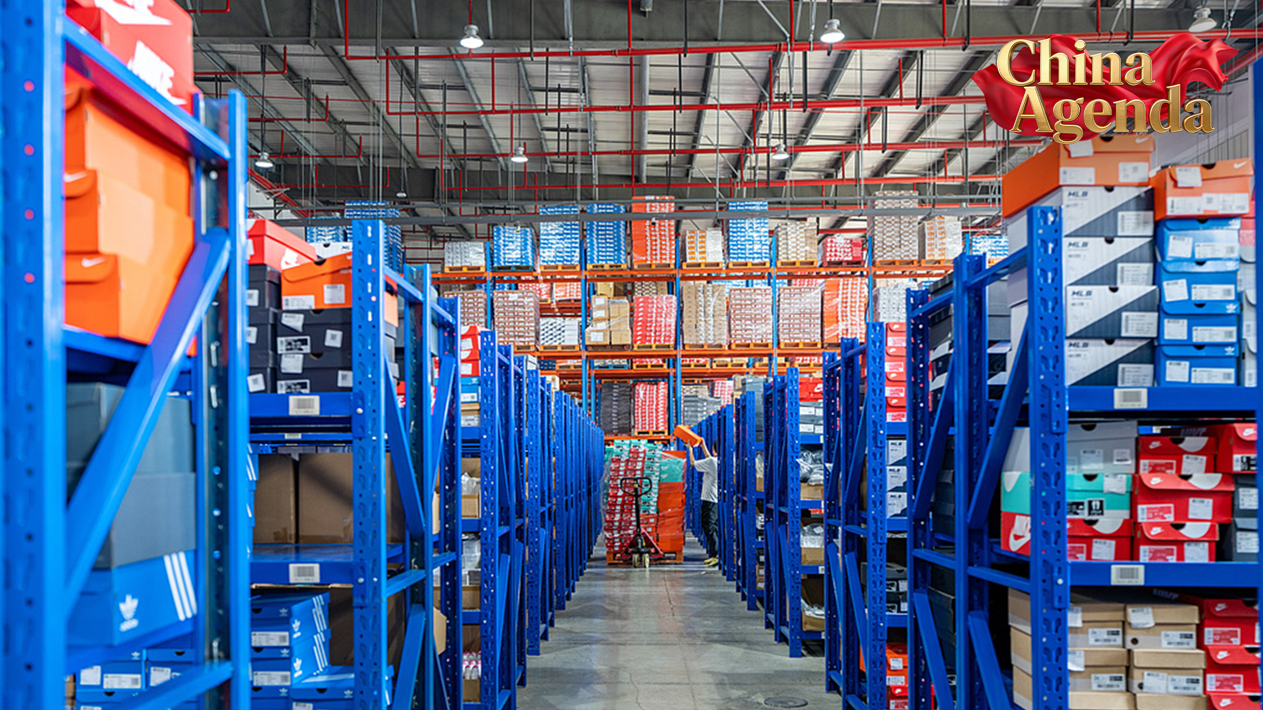 A warehouse staff is sorting and packaging goods for shelving, Jinhua City, eastern China's Zhejiang Province, June 13, 2025. /VCG