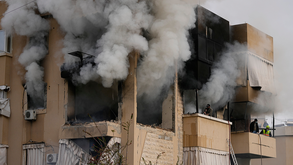 Rescue workers inspect an apartment damaged in an Israeli airstrike as thick smoke fills the building in the southern port city of Sidon, Lebanon, March 14, 2026. /VCG