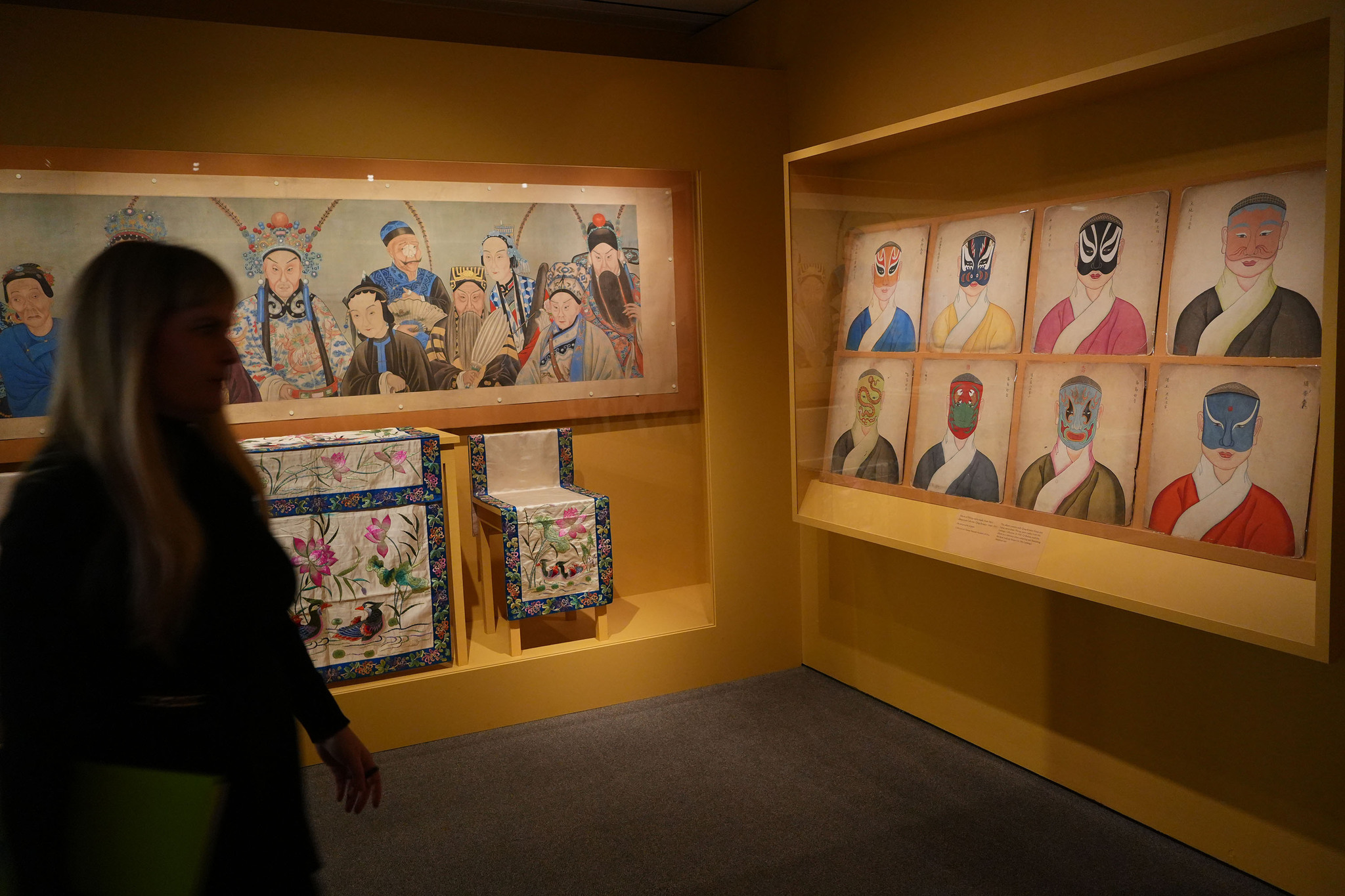 Visitors at the China Institute Gallery in New York on March 11, 2026 view exhibits of Qing Dynasty Peking Opera facial makeup designs once collected by Mei Lanfang. /VCG