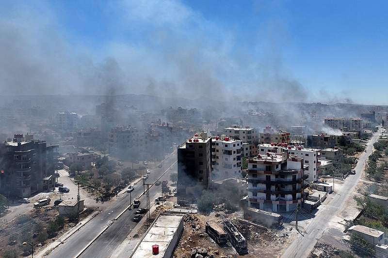This aerial view shows smoke rising in the city of Sweida in southern Syria's Druze majority province, July 19, 2025. /VCG
