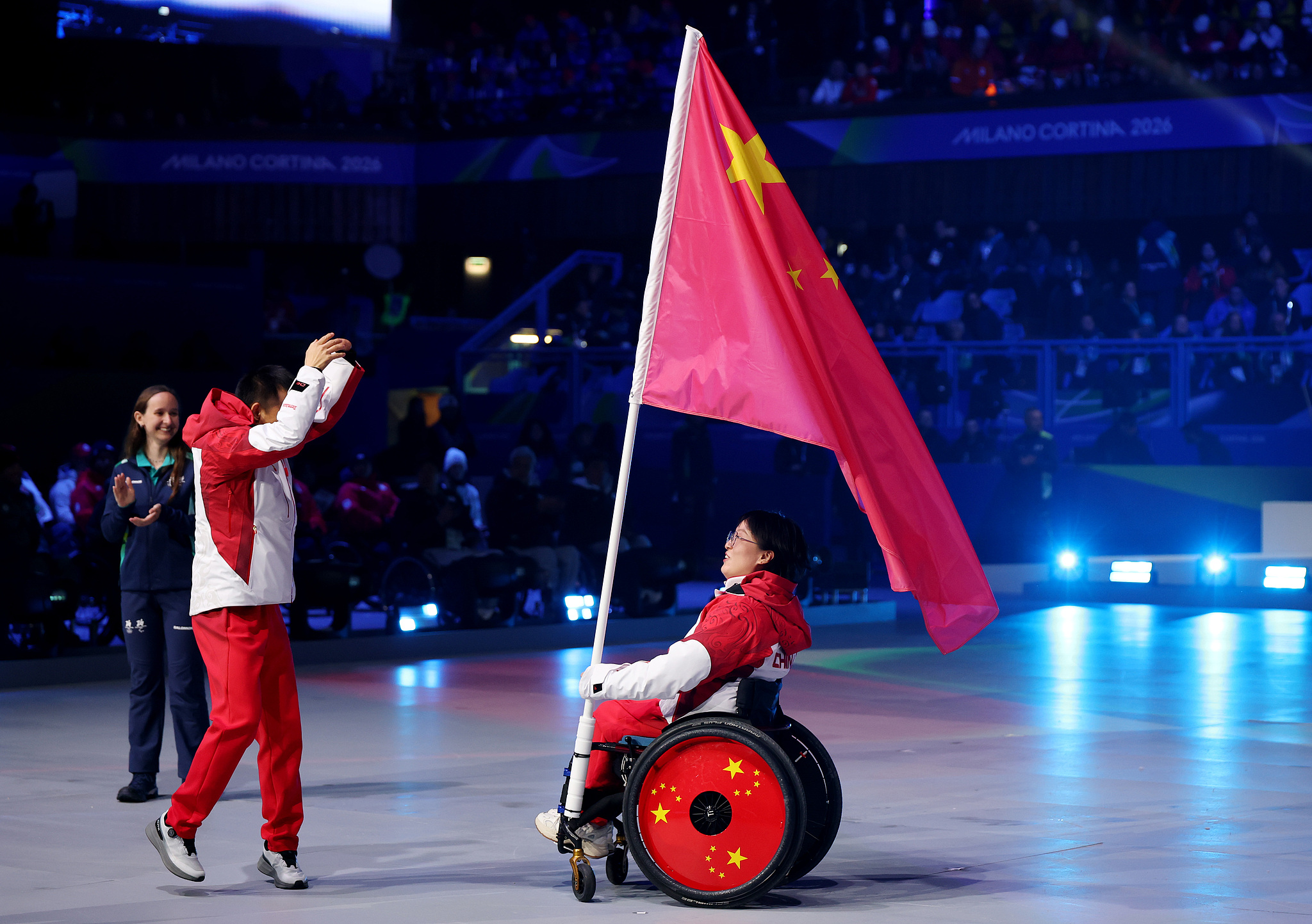 Flagbearers Cai Jiayun (L) and Wang Meng of China participate in the closing ceremony at the 2026 Milano Cortina Winter Paralympics at Cortina Curling Olympic Stadium in Cortina d'Ampezzo, Italy, March 15, 2026. /VCG