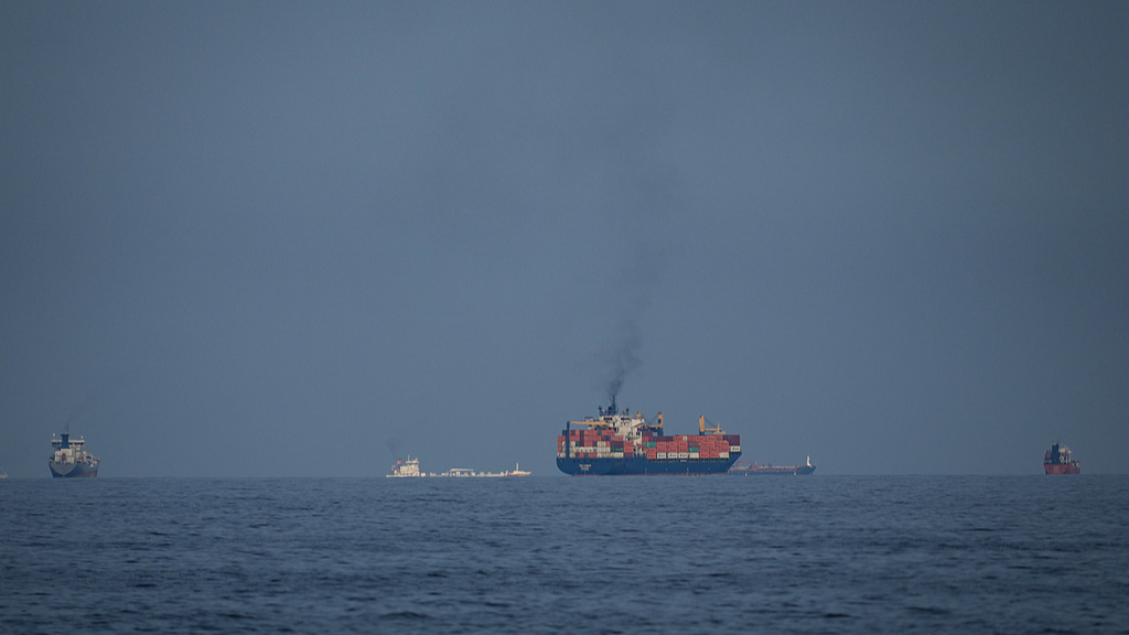 Oil tankers and cargo ships line up in the Strait of Hormuz as seen from Khor Fakkan, United Arab Emirates, March 11, 2026. /VCG