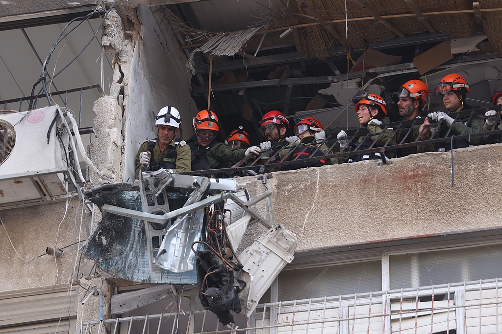 Teams work at the scene after an apartment building is hit by shrapnel from an Iranian missile in Bnei Brak, near Tel Aviv, Israel, March 15, 2026. /VCG