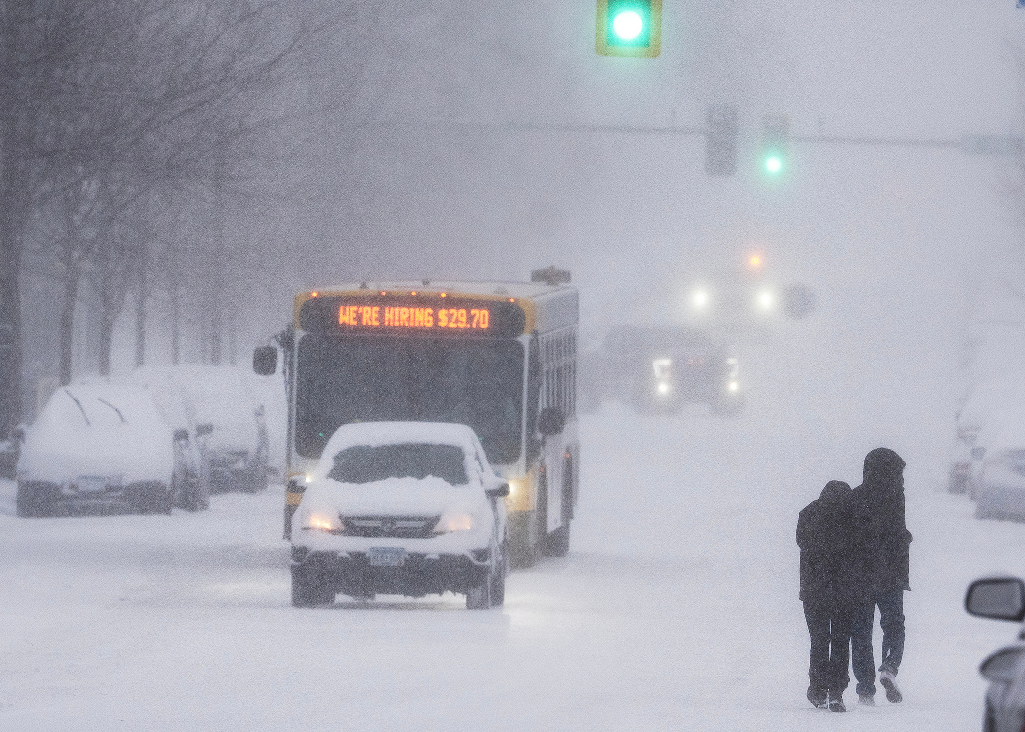 Pedestrians walk down Nicollet Avenue as vehicles pass by in Minneapolis, Minnesota, the US, March 15, 2026. /VCG