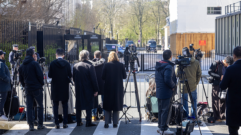 Journalists stand outside the Organisation for Economic Co-operation and Development (OECD) headquarters as Chinese and US delegations start economic and trade talks in Paris, France, March 15, 2026. /CFP