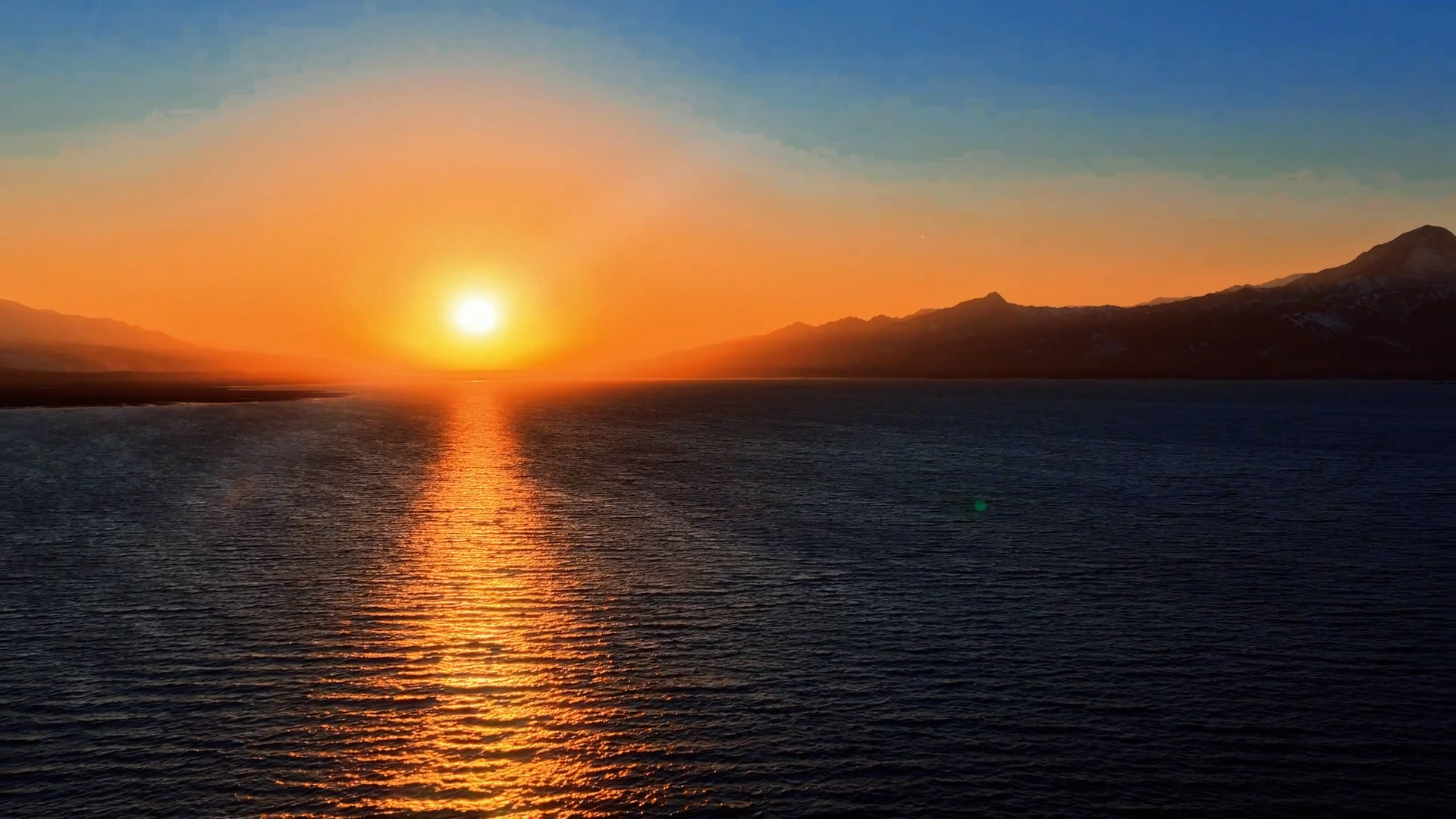 Spring ice melts into a sea of pink and gold