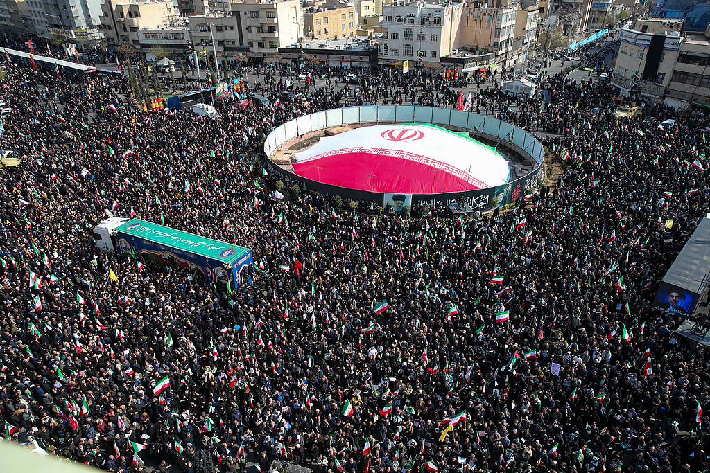 People gather and hold Iranian flags during the funeral of Iran's Supreme National Security Council Secretary, Ali Larijani, who was killed during the US-Israeli Iranian conflict, Tehran, Iran, March 18, 2026. /VCG
