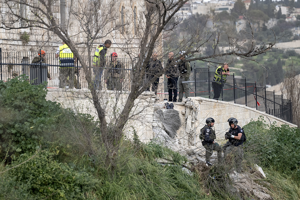 Security forces cordon off the area after a piece of a missile fell near the walls of the Old City, close to the Al-Aqsa Mosque compound in East Jerusalem, March 20, 2026. /VCG