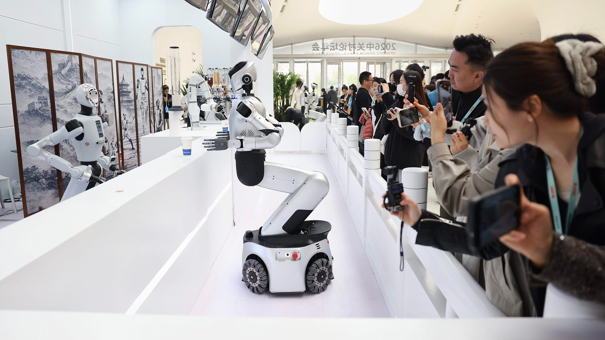 Robots collaborate to prepare coffee for guests at the 2026 ZGC Forum Annual Conference in Beijing, China, March 25, 2026. /VCG