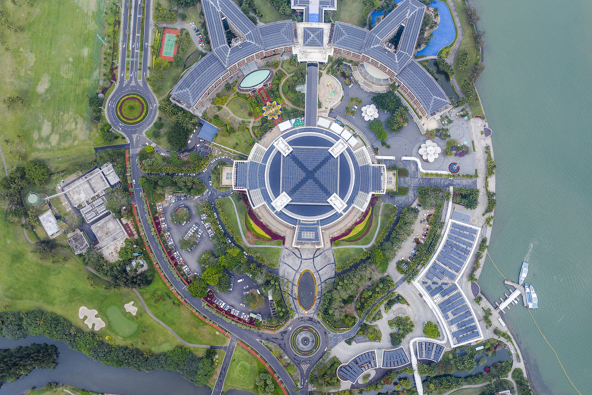 On the roof of the Boao Forum for Asia International Conference Center, rows of blue photovoltaic panels produce clean energy under the sunlight, in Qionghai, Hainan Province, February 26, 2024. /CFP