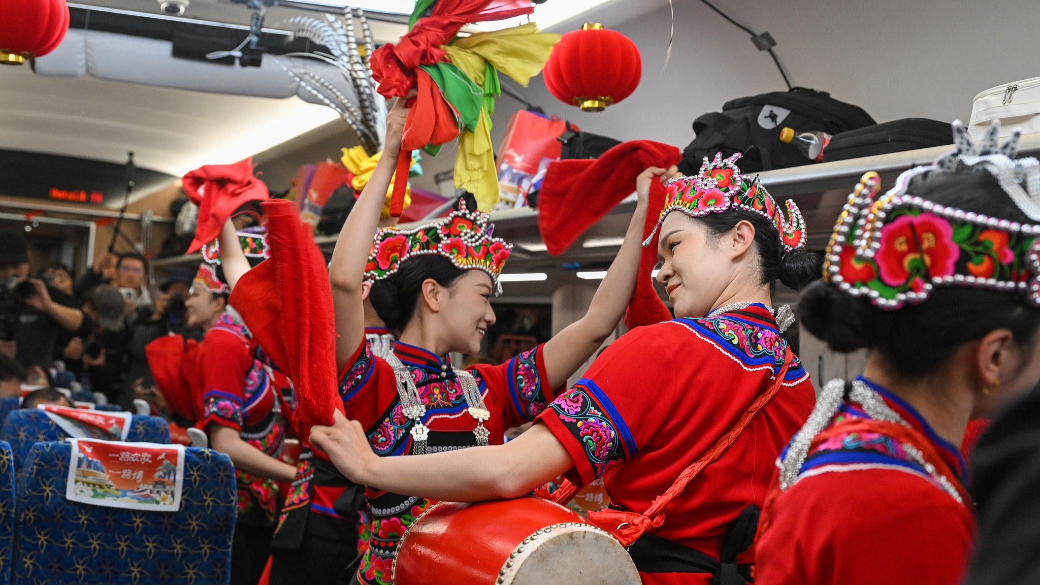 Flower drum artists perform on a passenger train running on the China-Laos Railway during a cultural event, February 4, 2026. /VCG