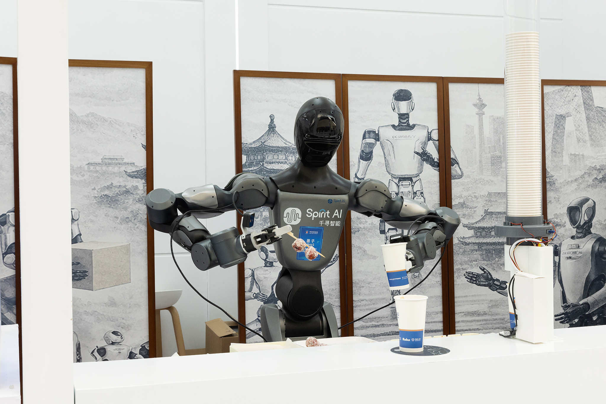 A robot prepares food at a booth at the 2026 Zhongguancun Forum Annual Conference Opening Ceremony in Beijing, China, March 25 2026. /VCG