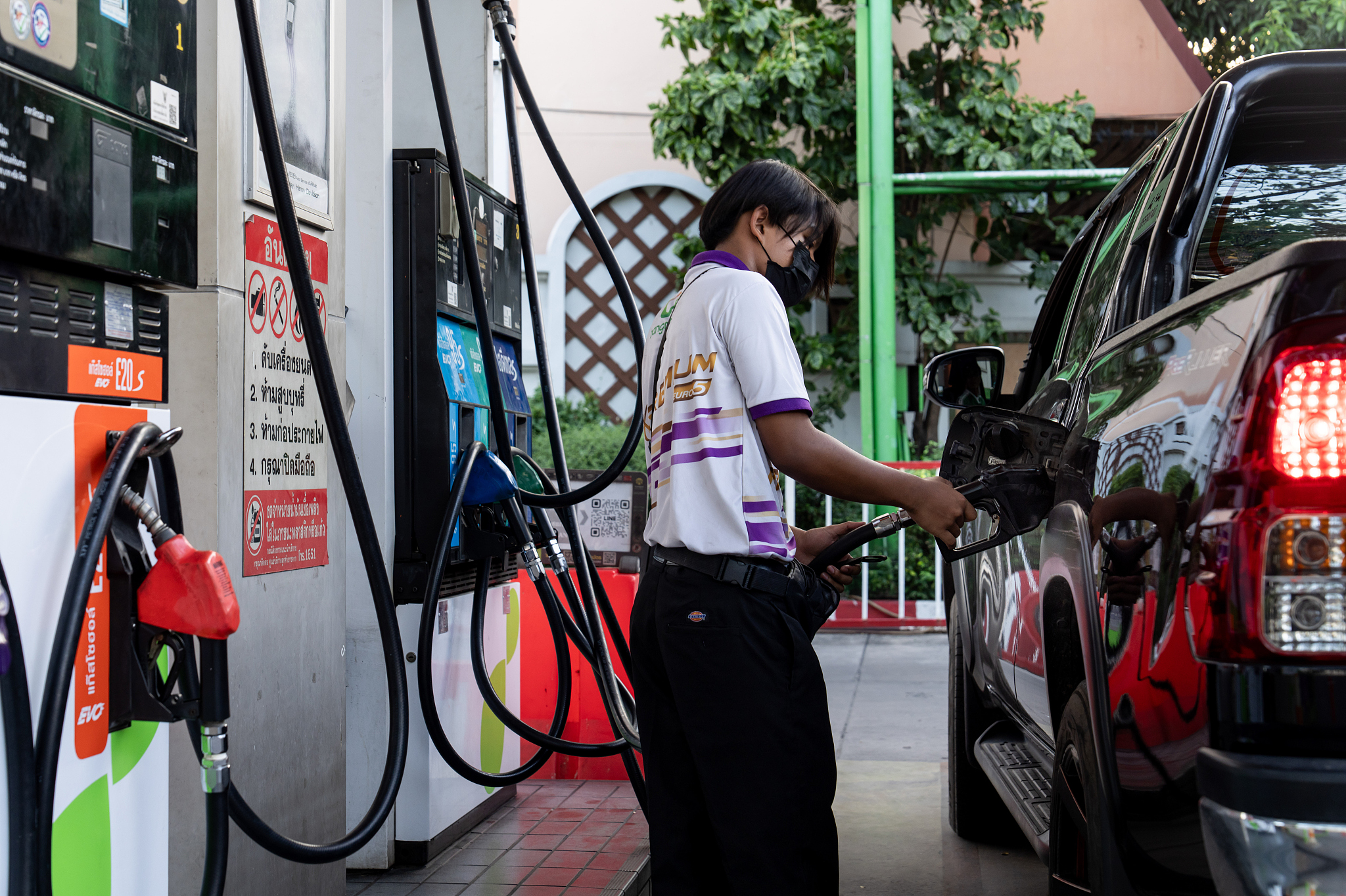 A gas station attendant refuels a truck at a gas station in Bangkok, Thailand, March 15, 2026. /VCG