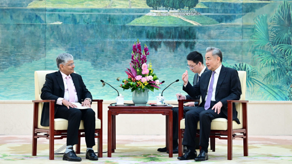 Chinese Foreign Minister Wang Yi (R) meets with outgoing Indian Ambassador to China Pradeep Kumar Rawat in Beijing, China, March 26, 2026. /Chinese Foreign Ministry